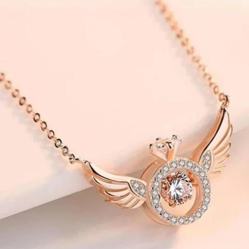 Rose gold necklace with angel wing design on a light background